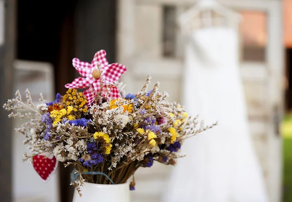 Bouquet and white wedding dress — Stock Photo, Image