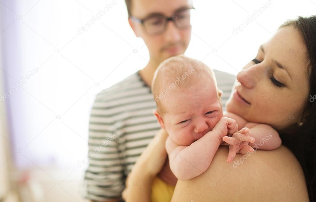Parents with their crying newborn baby girl