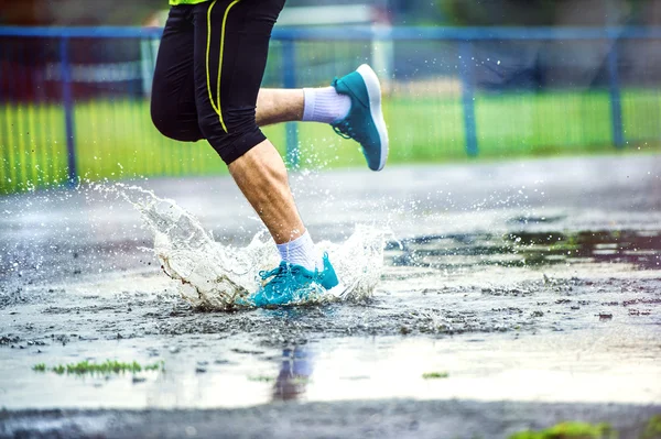Человек бежит в дождливую погоду — стоковое фото