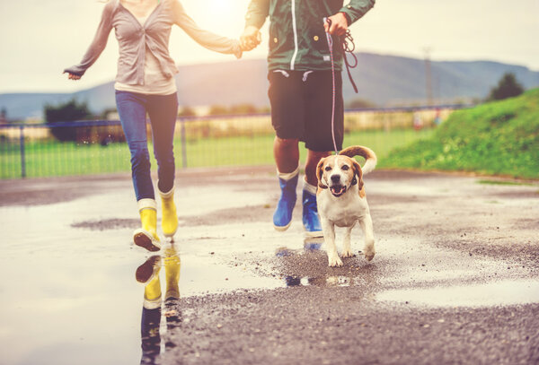 Couple running with dog