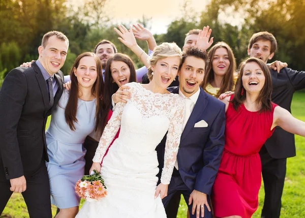 Newlywed couple having fun with bridesmaids and groomsmen — Stock Photo, Image