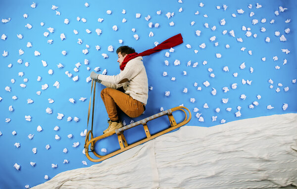 Young man on sled having fun