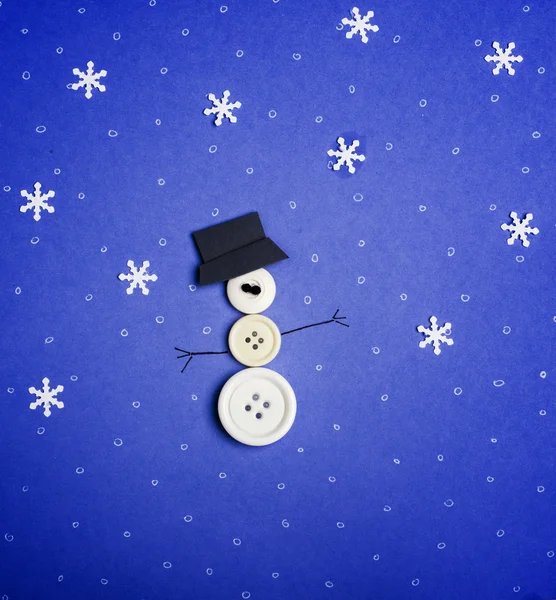 Снеговик из пуговиц и снежинки — стоковое фото