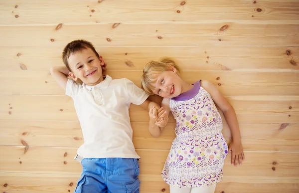 Two kids lying down on the floor — Stock Photo, Image