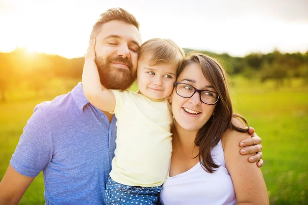 Mother, father and daughter at the meadow — Stock Photo, Image