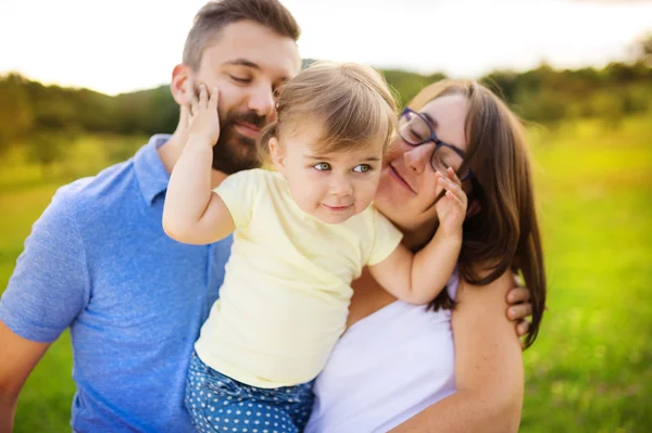 Mother, father and daughter at the meadow — Stock Photo, Image