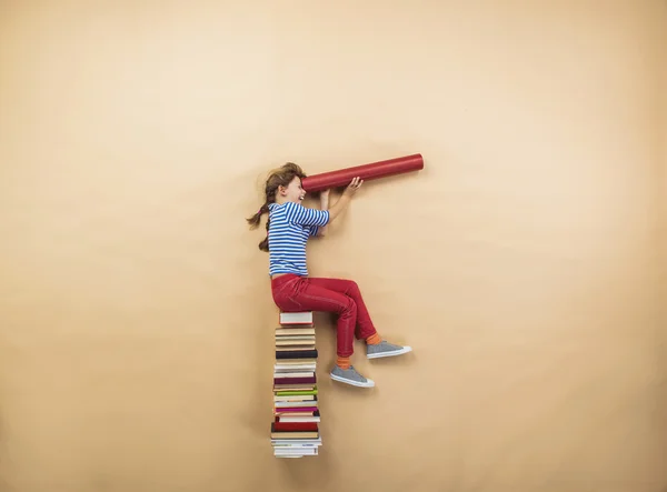 Girl is playing with group of books — Stock Photo, Image
