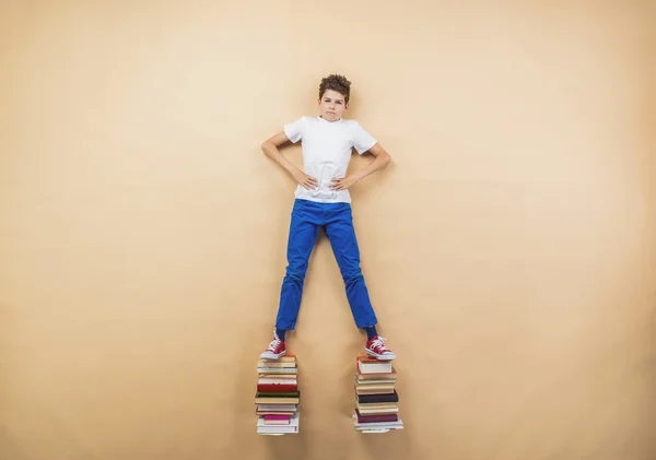 Boy is playing with group of books — Stock Photo, Image