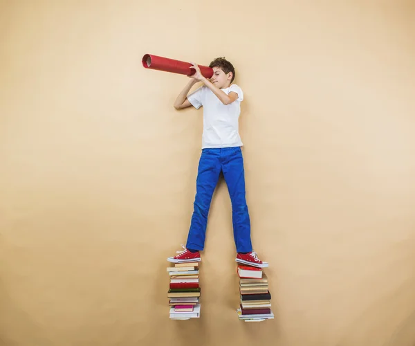 Boy is playing with group of books — Stock Photo, Image