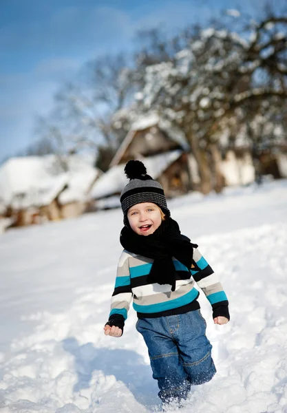Little boy playing in snow — Stock Photo, Image