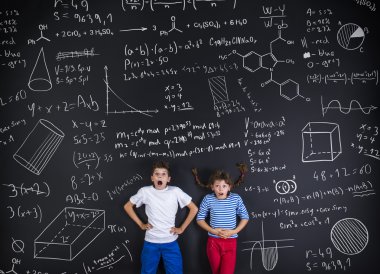 Erkek ve kız bir karatahta önünde öğrenme