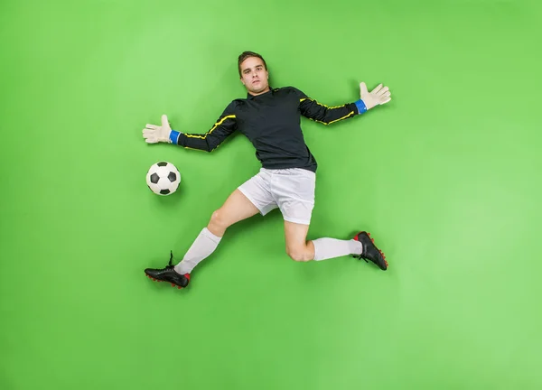 Goalkeeper in action catching a ball — Stock Photo, Image