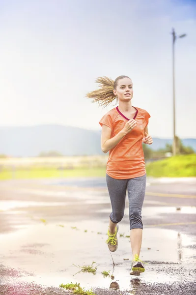 Woman running in rainy weather. — Stock Photo, Image