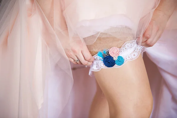 Bride getting dressed into her wedding gown. — Stock Photo, Image