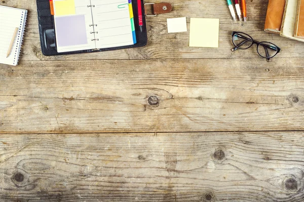 Mix of office supplies on a wooden table — Stock Photo, Image