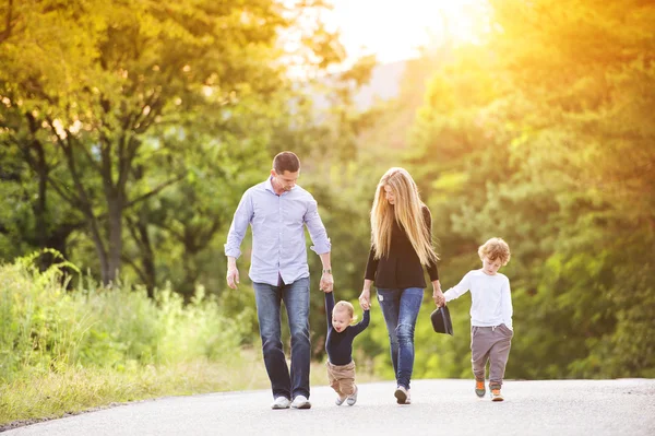 Family walking down the road — Stock Photo, Image