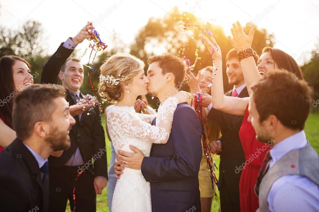 Newlyweds kissing at wedding reception