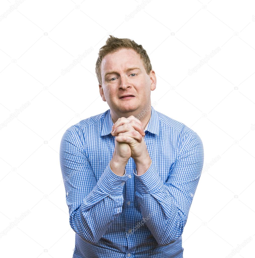 Man praying with clenched hands