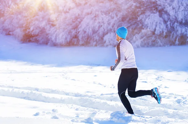 Sportsman jogging in winter — Stock Photo, Image