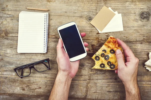 Desktop mix with gadget, supplies and pizza — Stock Photo, Image