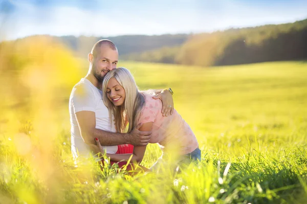 Ungt par i kärlek i soliga fält — Stockfoto