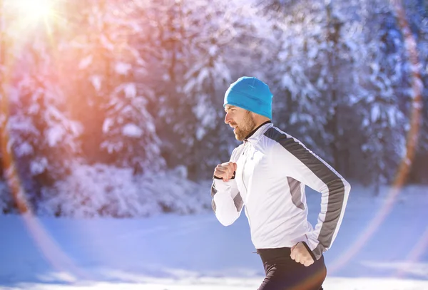 Sportsman jogging in winter — Stock Photo, Image