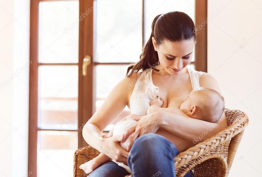 Mother breastfeeding her baby girl