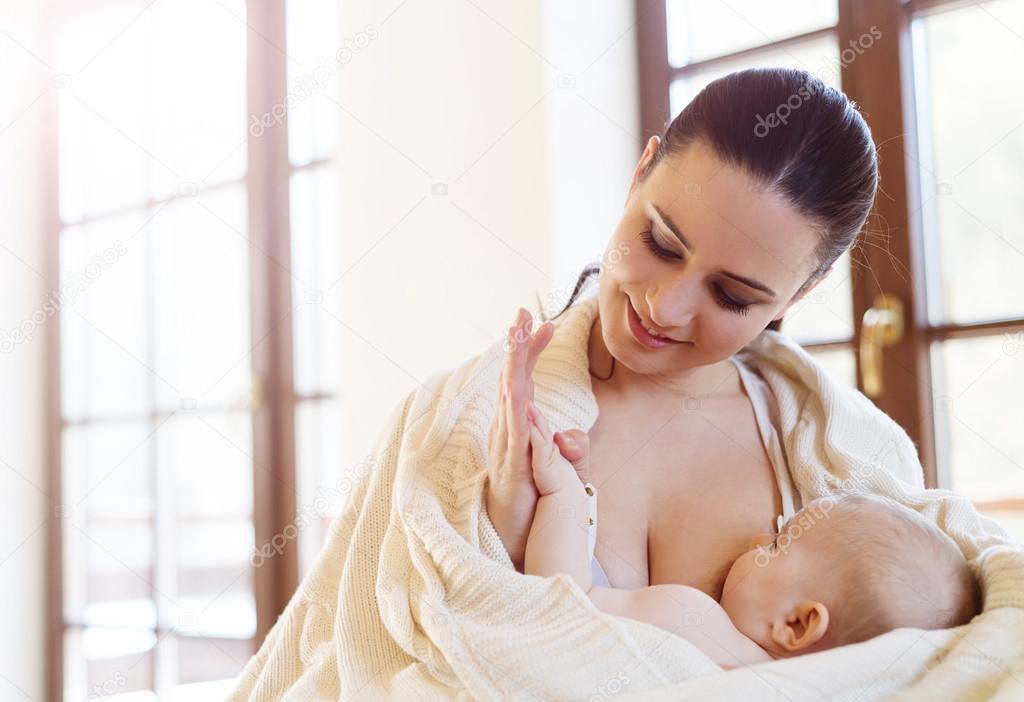 Mother breastfeeding her baby girl