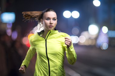 Woman jogging at night clipart