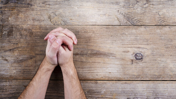 Hands of praying young man