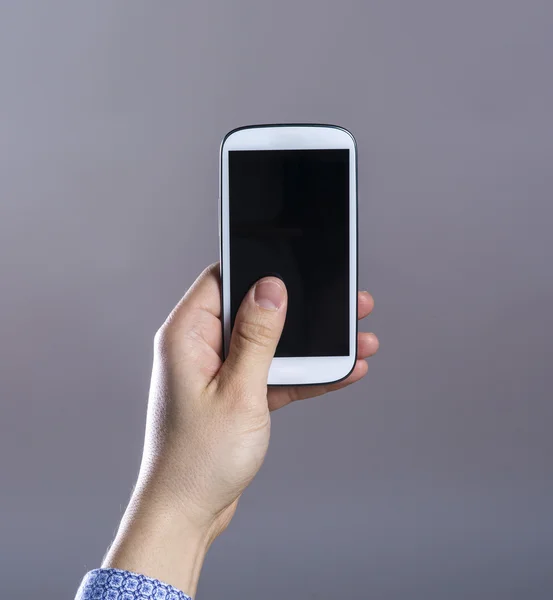 De Hipster hand met zijn slimme telefoon — Stockfoto