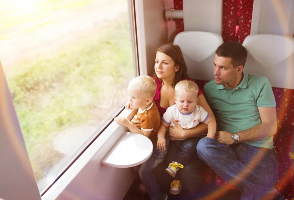 Family with two sons in train. — Stock Photo, Image