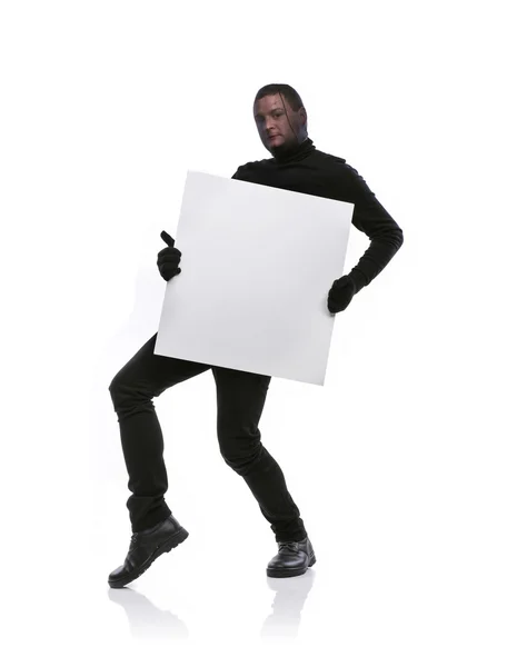 Thief with balaclava holding an empty banner — Stock Photo, Image