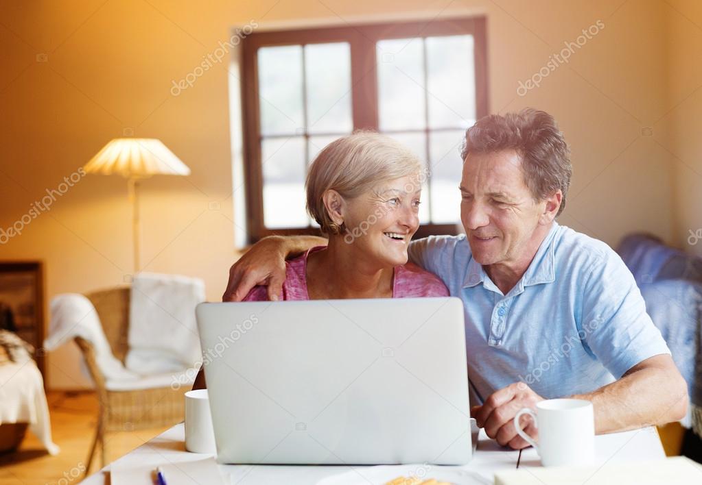 Senior couple working on laptop