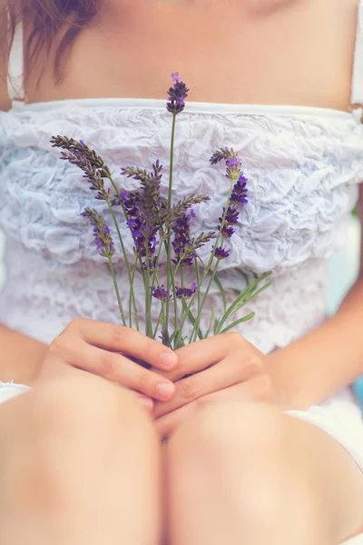 Woman holding lavender in her hands. — Stock Photo, Image