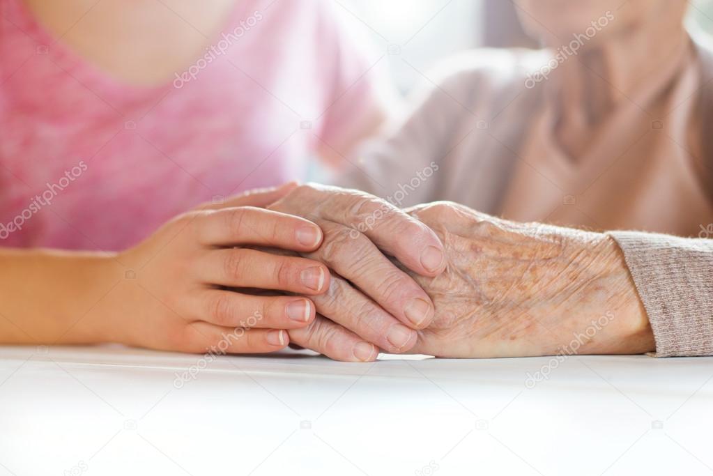 Grandmother and granddaughter holding hands.