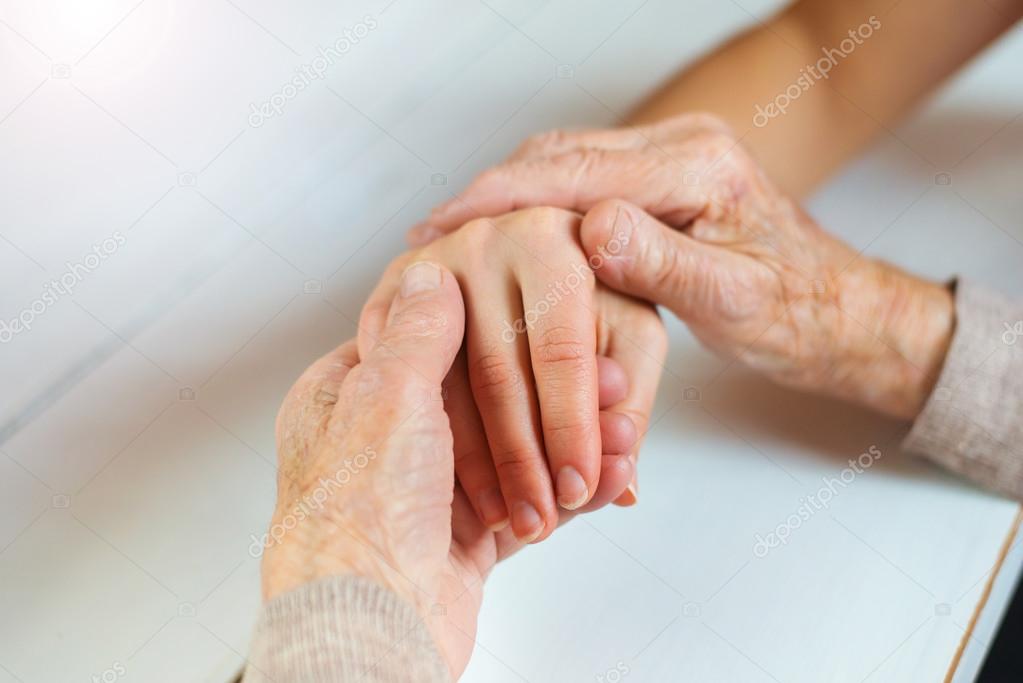 Grandmother and granddaughter holding hands.