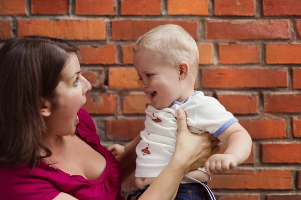 Mother holding her son on her hands — Stock Photo, Image