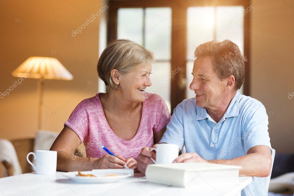 Senior couple making plans and drinking coffee