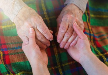 Grandmother and granddaughter holding hands. clipart