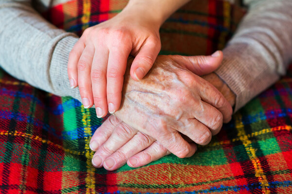 Grandmother and granddaughter holding hands.