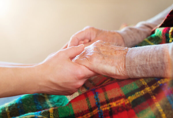 Grandmother and granddaughter holding hands.