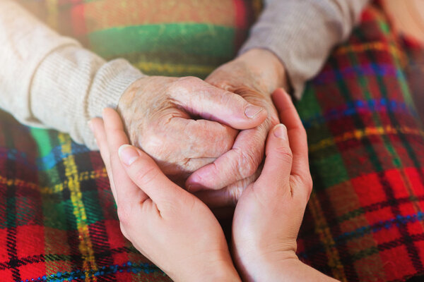Grandmother and granddaughter holding hands.