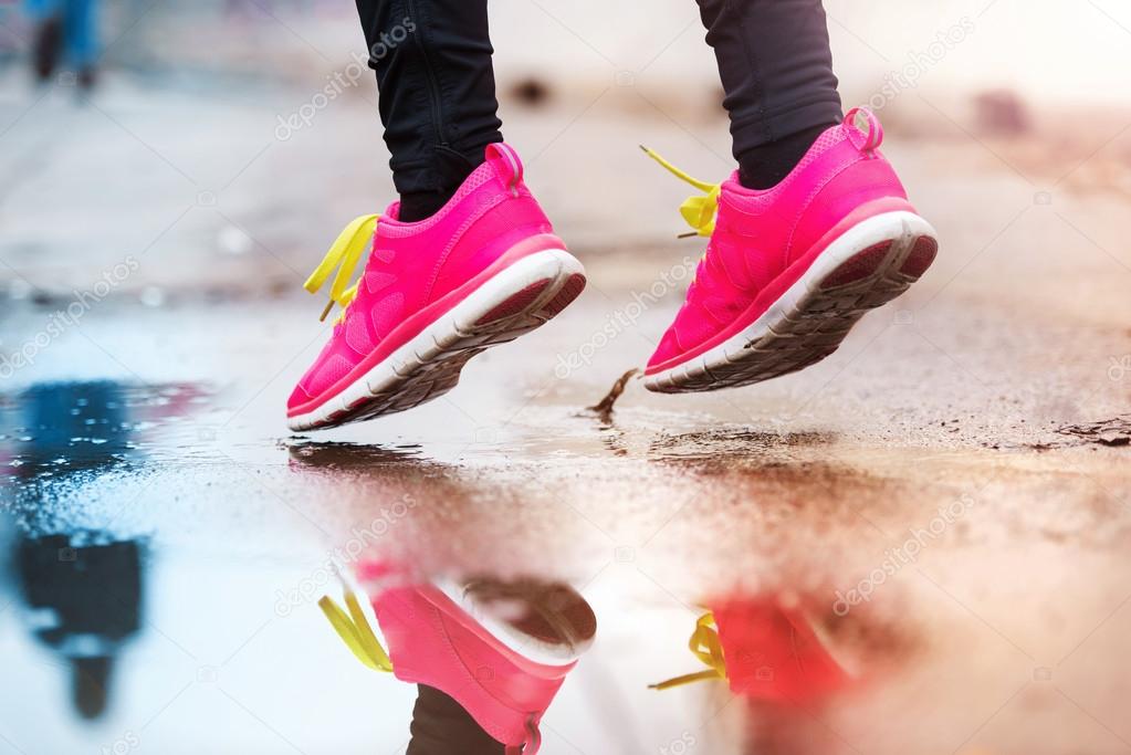 Woman running in rainy weather