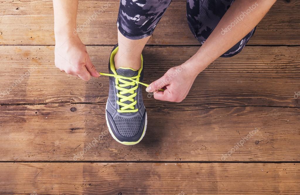 Runner tying her shoelaces. Stock Photo by ©halfpoint 70413247