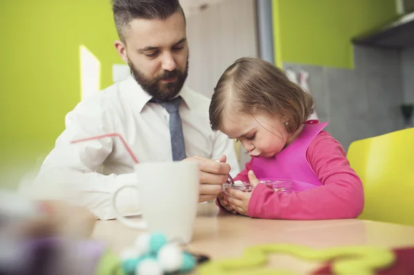 Father feeding his little daughter — Stock Photo, Image