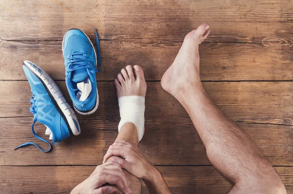 Injured runner with blue shoes — Stock Image Injured runner with blue shoes Stock Image