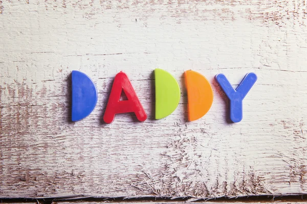 Papà segno e giocattoli colorati — Foto Stock