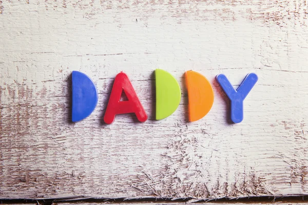 Daddy sign and colorful toys — Stock Photo, Image