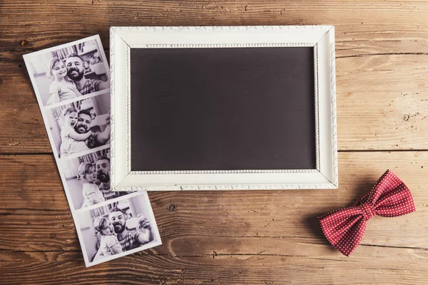 Picture frame, instant photos and a bow tie — Stock Photo, Image